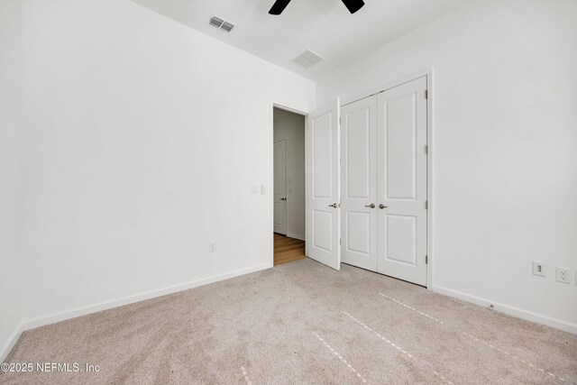 329 Rum Runner Way, Saint Johns, FL 32259 - unfurnished bedroom with carpet flooring, baseboards, a closet, and a ceiling fan