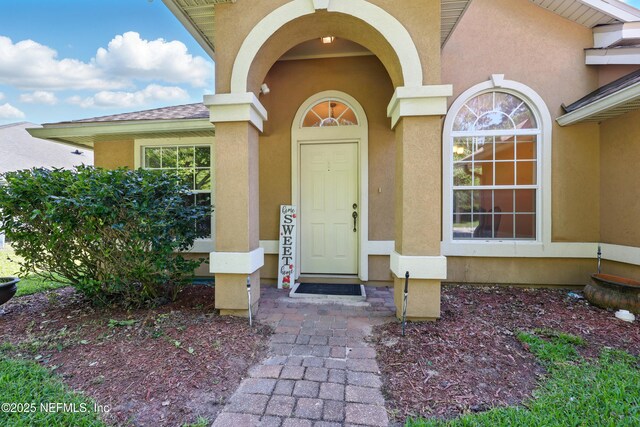 372 Johns Creek Pkwy, Saint Augustine, FL 32092 - doorway to property featuring stucco siding