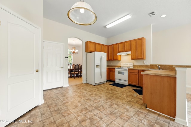 372 Johns Creek Pkwy, Saint Augustine, FL 32092 - kitchen featuring white appliances, a peninsula, under cabinet range hood, a sink, and light stone finish floors