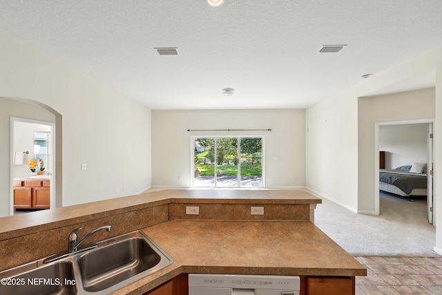 372 Johns Creek Pkwy, Saint Augustine, FL 32092 - kitchen featuring open floor plan, a sink, white dishwasher, and arched walkways
