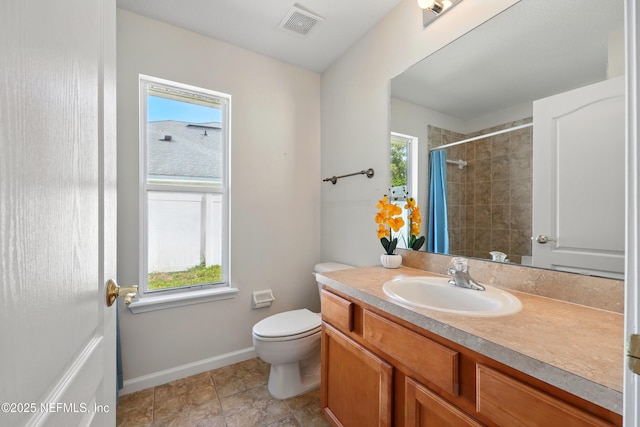372 Johns Creek Pkwy, Saint Augustine, FL 32092 - full bath featuring toilet, vanity, a tile shower, baseboards, and tile patterned floors