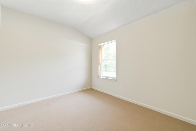372 Johns Creek Pkwy, Saint Augustine, FL 32092 - empty room with vaulted ceiling, light colored carpet, and baseboards