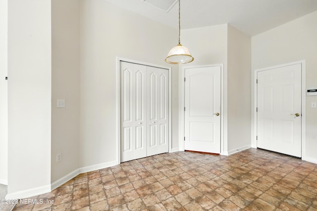 372 Johns Creek Pkwy, Saint Augustine, FL 32092 - unfurnished bedroom featuring stone finish floors, a closet, and baseboards
