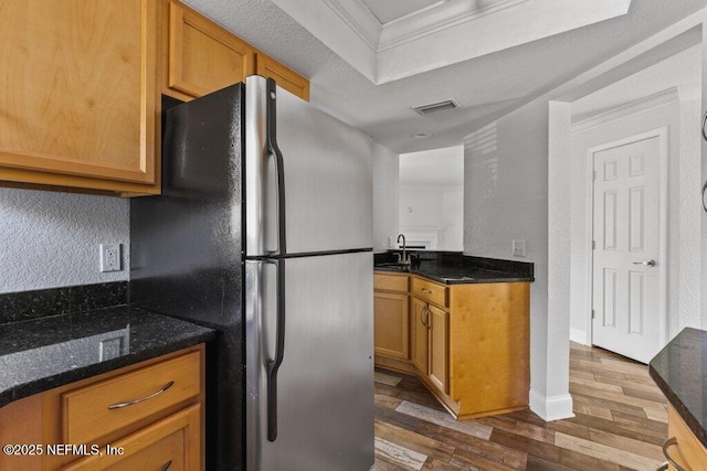 833 Shoreline Cir, Ponte Vedra Beach, FL 32082 - kitchen with a sink, wood finished floors, freestanding refrigerator, ornamental molding, and dark stone counters