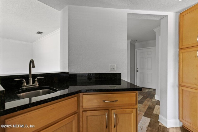 833 Shoreline Cir, Ponte Vedra Beach, FL 32082 - kitchen with a sink, crown molding, dark stone countertops, dark wood-type flooring, and a textured ceiling