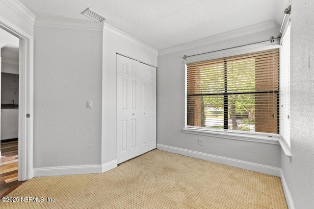 833 Shoreline Cir, Ponte Vedra Beach, FL 32082 - unfurnished bedroom with ornamental molding, carpet floors, a closet, baseboards, and a textured wall