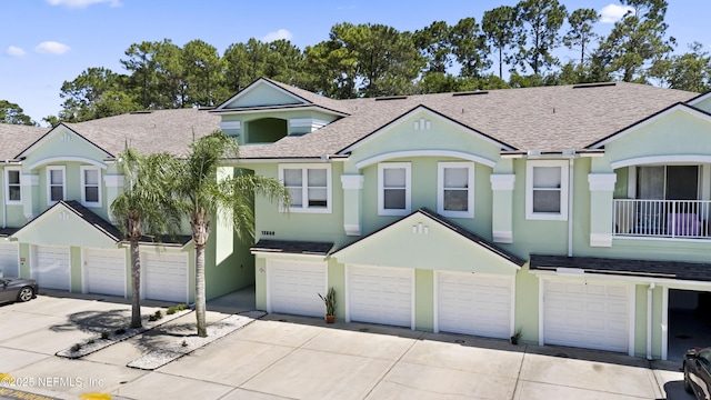 13808 Herons Landing Way Unit 8, Jacksonville, FL 32224 - townhome / multi-family property with roof with shingles, driveway, an attached garage, and stucco siding