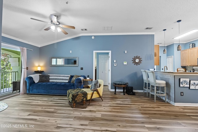 13808 Herons Landing Way Unit 8, Jacksonville, FL 32224 - living area with wood finished floors, lofted ceiling, ceiling fan, crown molding, and a textured ceiling