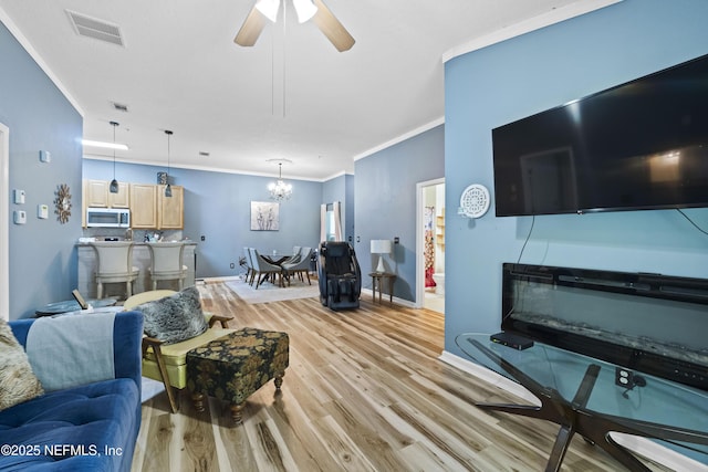 13808 Herons Landing Way Unit 8, Jacksonville, FL 32224 - living area featuring crown molding, light wood-style floors, a chandelier, baseboards, and ceiling fan