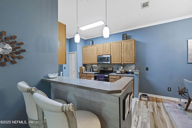 13808 Herons Landing Way Unit 8, Jacksonville, FL 32224 - kitchen featuring stainless steel appliances, light wood-type flooring, a kitchen breakfast bar, a peninsula, and tasteful backsplash