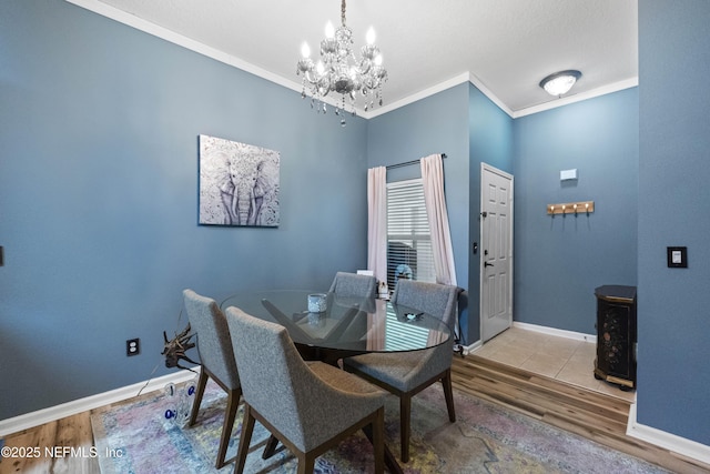 13808 Herons Landing Way Unit 8, Jacksonville, FL 32224 - dining area featuring a chandelier, wood finished floors, ornamental molding, baseboards, and a wood stove