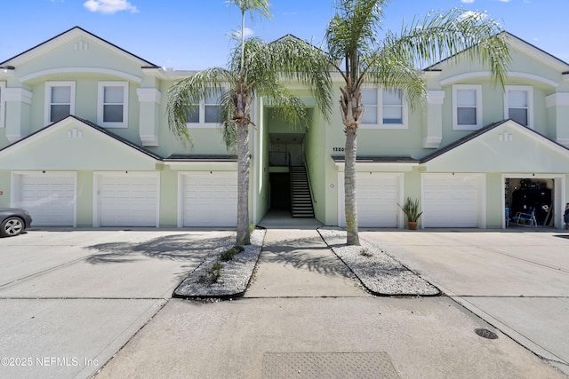 13808 Herons Landing Way Unit 8, Jacksonville, FL 32224 - view of property featuring an attached garage, driveway, and stucco siding