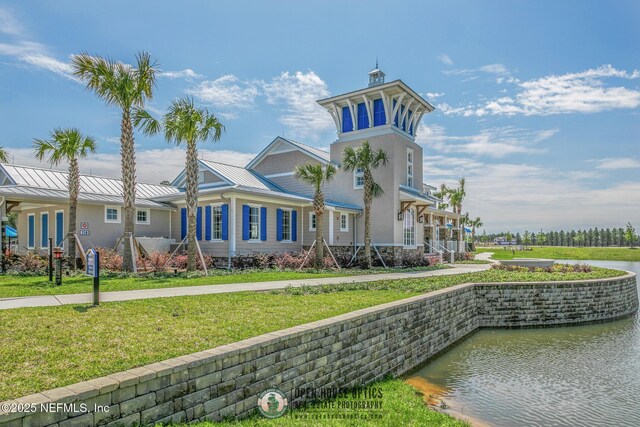 712 Cherry Elm Dr, Saint Augustine, FL 32092 - view of front of house featuring a standing seam roof, a front yard, metal roof, and a water view