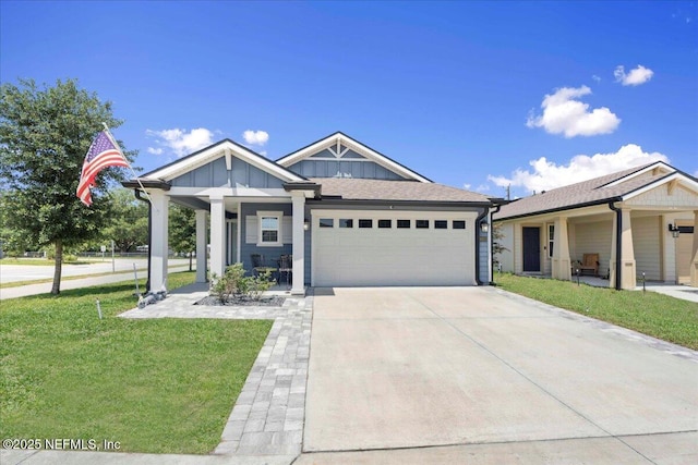 86815 Iron Rail Ct, Yulee, FL 32097 - view of front of home with an attached garage, driveway, a front yard, board and batten siding, and a porch