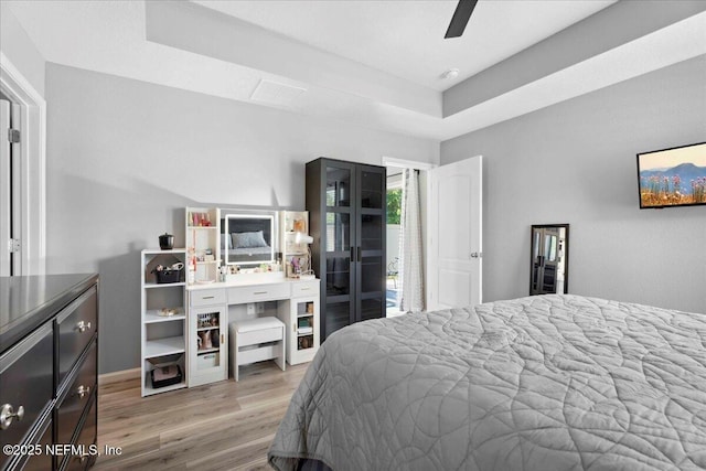 86815 Iron Rail Ct, Yulee, FL 32097 - bedroom with a tray ceiling, light wood-style flooring, baseboards, and a ceiling fan