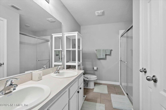 86815 Iron Rail Ct, Yulee, FL 32097 - full bathroom featuring a shower stall, toilet, double vanity, tile patterned flooring, and baseboards
