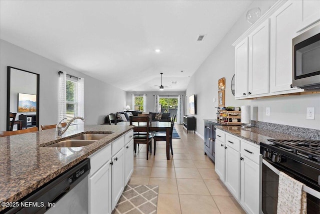 86815 Iron Rail Ct, Yulee, FL 32097 - kitchen featuring a sink, stainless steel appliances, ceiling fan, white cabinetry, and dark stone counters