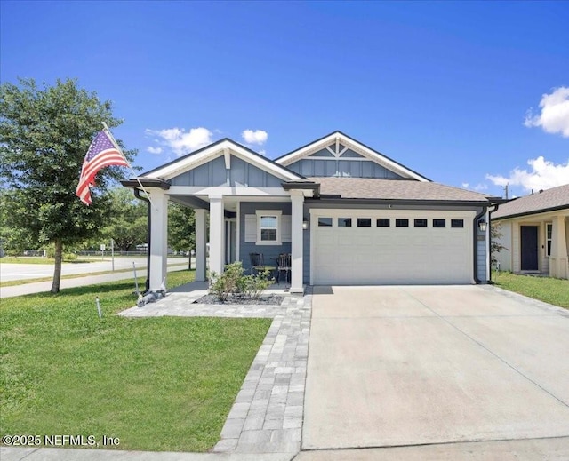 86815 Iron Rail Ct, Yulee, FL 32097 - view of front facade with an attached garage, board and batten siding, a front lawn, and driveway