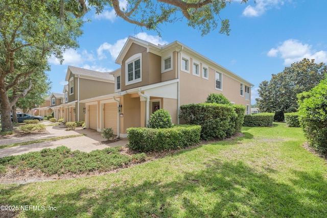 11889 Surfbird Cir Unit 10F, Jacksonville, FL 32256 - view of side of property with stucco siding, a yard, and driveway