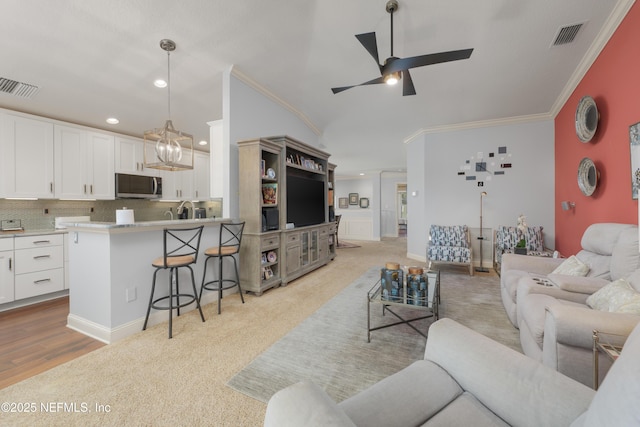 11889 Surfbird Cir Unit 10F, Jacksonville, FL 32256 - living area featuring ornamental molding, ceiling fan, recessed lighting, and light carpet