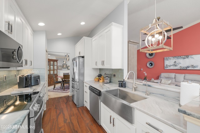 11889 Surfbird Cir Unit 10F, Jacksonville, FL 32256 - kitchen with appliances with stainless steel finishes, a sink, dark wood-style flooring, decorative backsplash, and white cabinetry