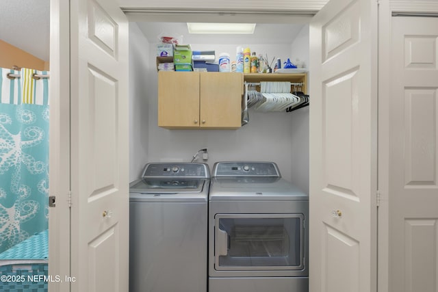 11889 Surfbird Cir Unit 10F, Jacksonville, FL 32256 - laundry room featuring cabinet space and washing machine and clothes dryer