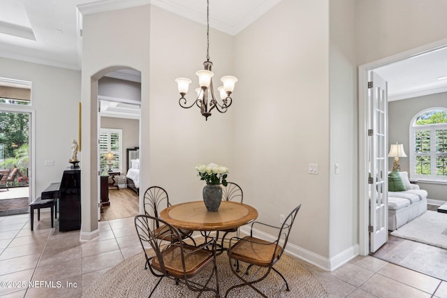 33 Tinker Ct, Fruit Cove, FL 32259 - dining room featuring light tile patterned floors, arched walkways, ornamental molding, and baseboards