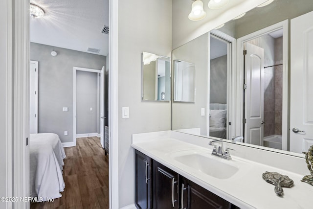 33 Tinker Ct, Fruit Cove, FL 32259 - ensuite bathroom featuring vanity, baseboards, wood finished floors, and shower / washtub combination