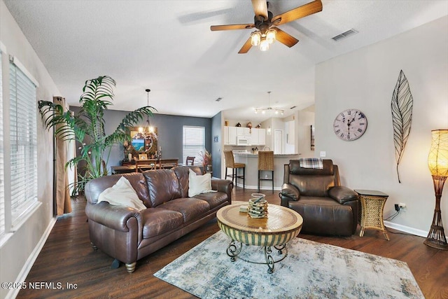 589 Prosperity Lake Dr, Saint Augustine, FL 32092 - living area featuring ceiling fan, dark wood finished floors, baseboards, a chandelier, and vaulted ceiling