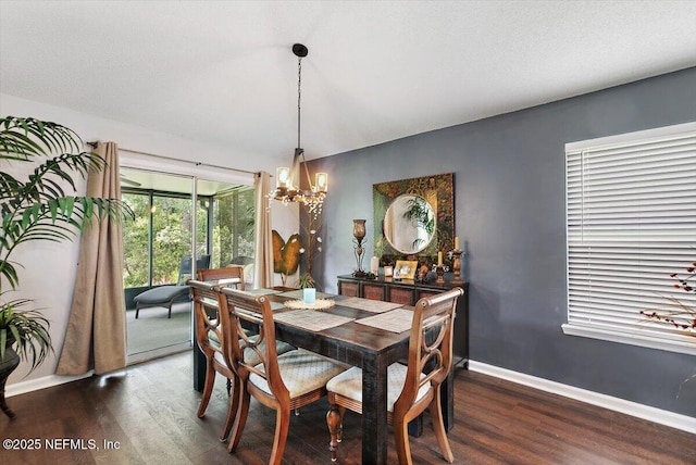 589 Prosperity Lake Dr, Saint Augustine, FL 32092 - dining area with a chandelier, dark wood finished floors, and baseboards