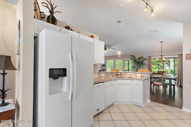 589 Prosperity Lake Dr, Saint Augustine, FL 32092 - kitchen with white appliances, a peninsula, white cabinets, and decorative light fixtures
