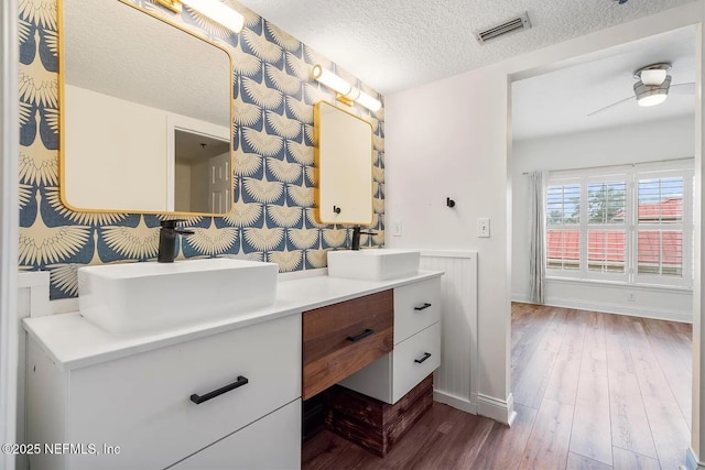 12 Flagler Blvd Unit A203, Saint Augustine, FL 32080 - bathroom with double vanity, a textured ceiling, wood finished floors, and baseboards