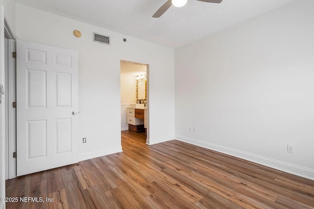 12 Flagler Blvd Unit A203, Saint Augustine, FL 32080 - unfurnished bedroom with wood finished floors, baseboards, ceiling fan, and ensuite bathroom