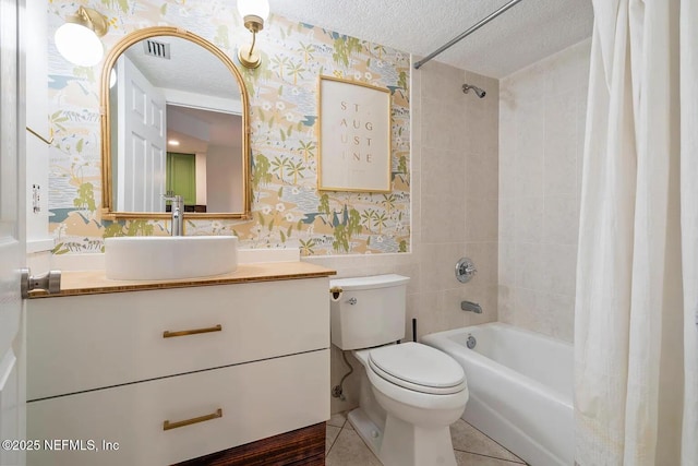 12 Flagler Blvd Unit A203, Saint Augustine, FL 32080 - bathroom featuring wallpapered walls, a textured ceiling, shower / bath combination with curtain, toilet, and vanity