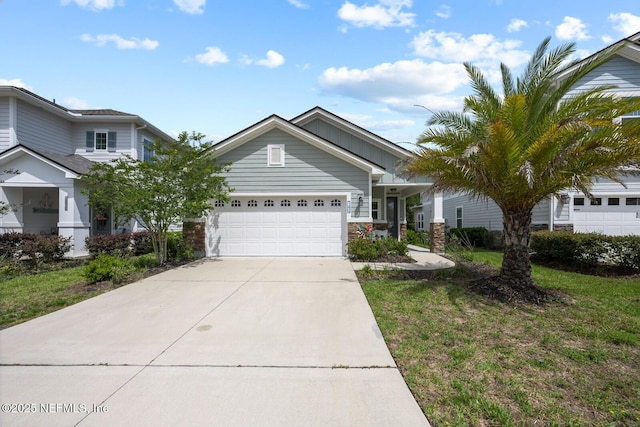 149 Ferndale Way, Saint Augustine, FL 32092 - view of front of home featuring an attached garage, concrete driveway, stone siding, and a front lawn