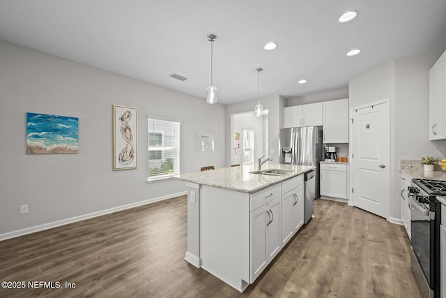 149 Ferndale Way, Saint Augustine, FL 32092 - kitchen featuring appliances with stainless steel finishes, dark wood-type flooring, a sink, white cabinets, and light stone counters
