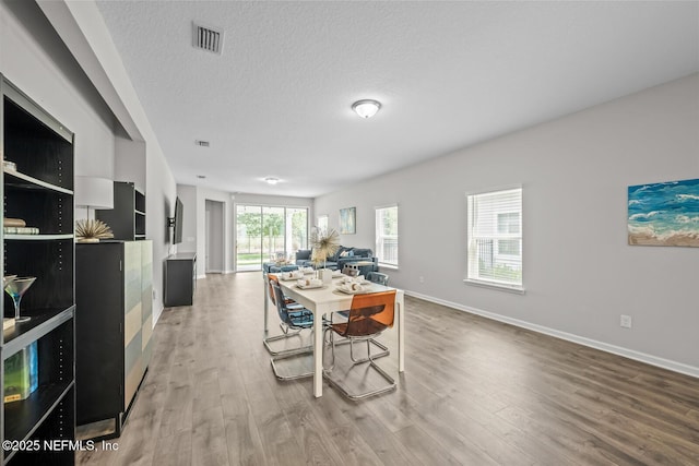 149 Ferndale Way, Saint Augustine, FL 32092 - dining area featuring wood finished floors, baseboards, and a textured ceiling