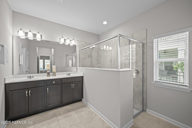 149 Ferndale Way, Saint Augustine, FL 32092 - bathroom with tile patterned floors, double vanity, a stall shower, baseboards, and recessed lighting