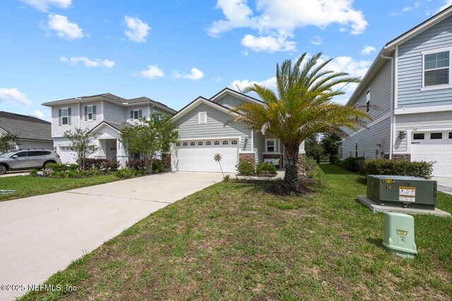 149 Ferndale Way, Saint Augustine, FL 32092 - view of front of house with driveway, stone siding, a front lawn, and an attached garage
