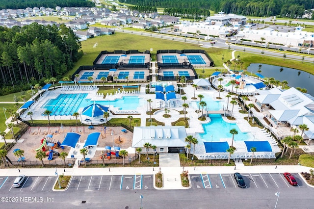 121 Thistleton Way, Saint Augustine, FL 32092 - bird's eye view of a pool, a large body of water, and a heavily wooded area