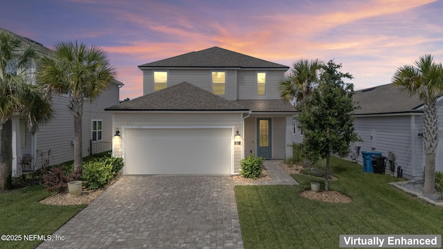 121 Thistleton Way, Saint Augustine, FL 32092 - traditional home with an attached garage, decorative driveway, a yard, and a shingled roof
