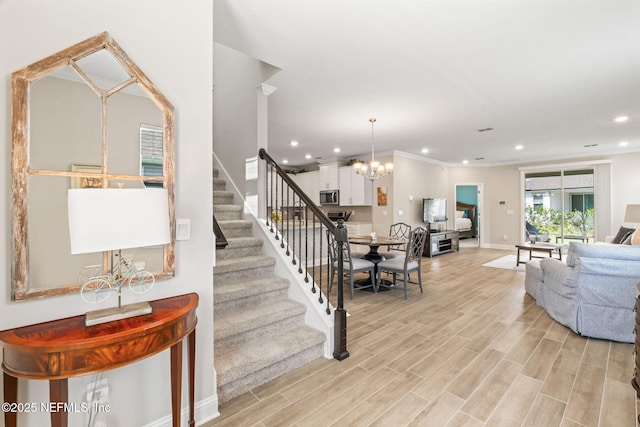 121 Thistleton Way, Saint Augustine, FL 32092 - stairway featuring recessed lighting, a chandelier, baseboards, and wood finished floors