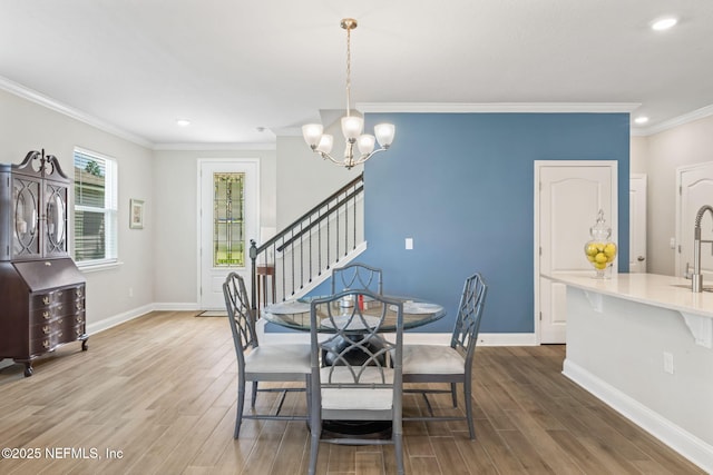 121 Thistleton Way, Saint Augustine, FL 32092 - dining area featuring wood finished floors, a chandelier, ornamental molding, recessed lighting, and baseboards