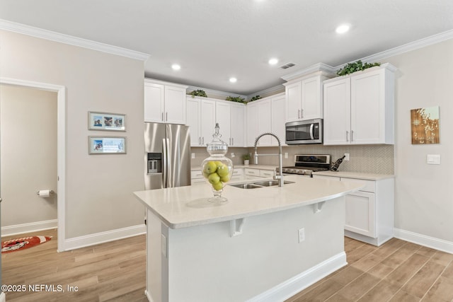 121 Thistleton Way, Saint Augustine, FL 32092 - kitchen featuring stainless steel appliances, crown molding, light wood-style floors, baseboards, and a sink