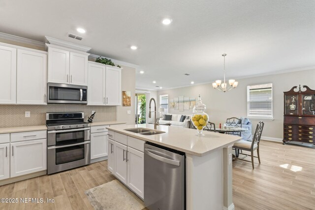 121 Thistleton Way, Saint Augustine, FL 32092 - kitchen with appliances with stainless steel finishes, a sink, crown molding, light countertops, and plenty of natural light
