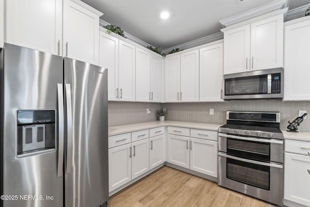 121 Thistleton Way, Saint Augustine, FL 32092 - kitchen with stainless steel appliances, light countertops, tasteful backsplash, white cabinetry, and recessed lighting