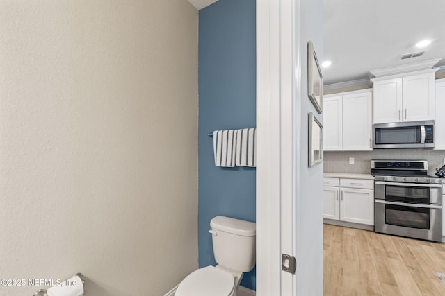 121 Thistleton Way, Saint Augustine, FL 32092 - bathroom featuring toilet, tasteful backsplash, wood finished floors, and recessed lighting