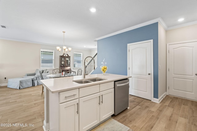 121 Thistleton Way, Saint Augustine, FL 32092 - kitchen with dishwasher, a sink, ornamental molding, light wood-style floors, and a chandelier