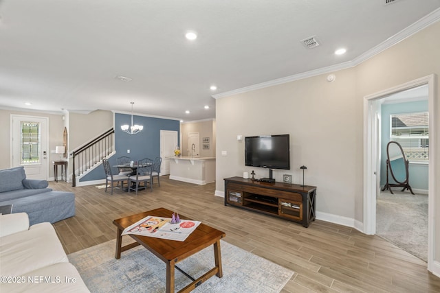 121 Thistleton Way, Saint Augustine, FL 32092 - living room featuring crown molding, a chandelier, baseboards, stairway, and light wood-type flooring