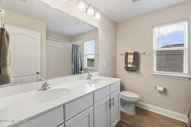 121 Thistleton Way, Saint Augustine, FL 32092 - bathroom with toilet, wood finished floors, double vanity, baseboards, and a shower with curtain